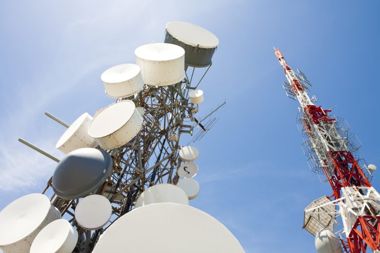 mobile phone and telecommunication towers against blue sky